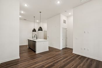 A kitchen with a white cabinet and a sink is shown